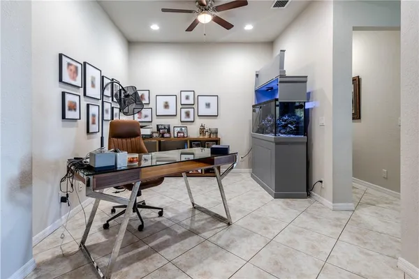 a work room with furniture and a bookshelf