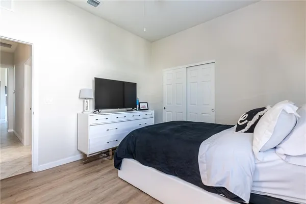 a bedroom with a bed and a flat screen tv