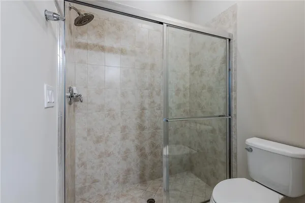 a bathroom with a shower and a toilet