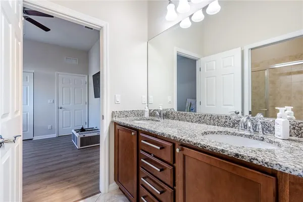 a bathroom with a granite countertop sink and a mirror