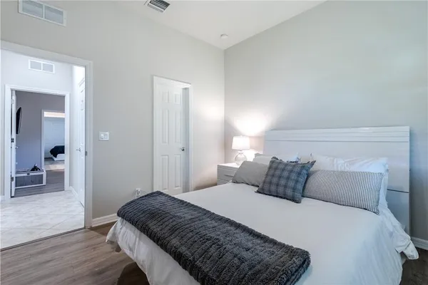 a bedroom with a bed and wooden floor