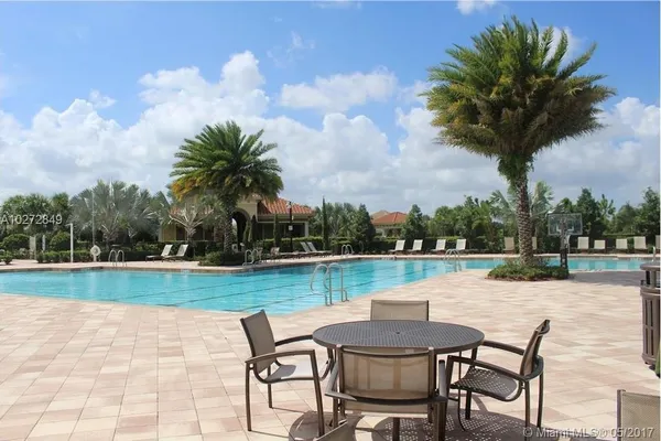 a view of a house with garden and a patio