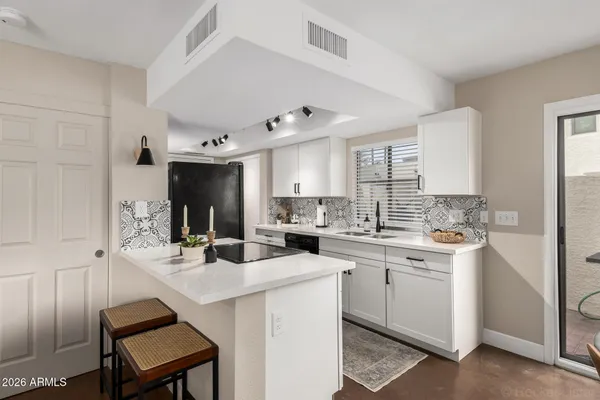 a kitchen with a sink stove and cabinets