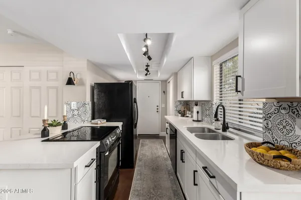 a kitchen with a sink stove and refrigerator