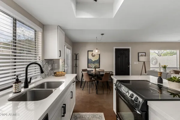 a kitchen with a sink a counter and chairs