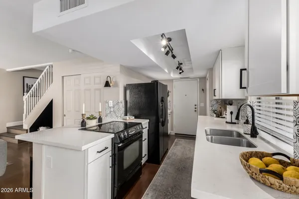 a kitchen that has a sink and a stove