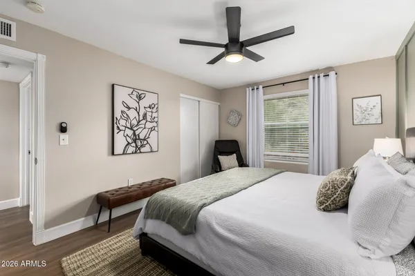 a bedroom with a large bed and a window
