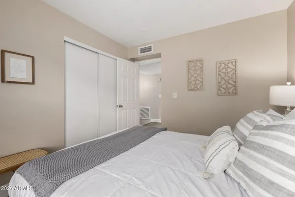 a bedroom with a bed and a lamp