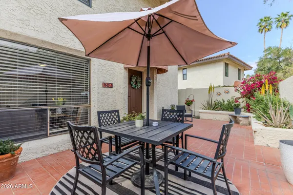 a view of a backyard with furniture and flowers