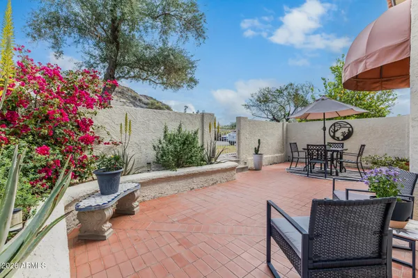 a view of a patio with couches and table and potted plants