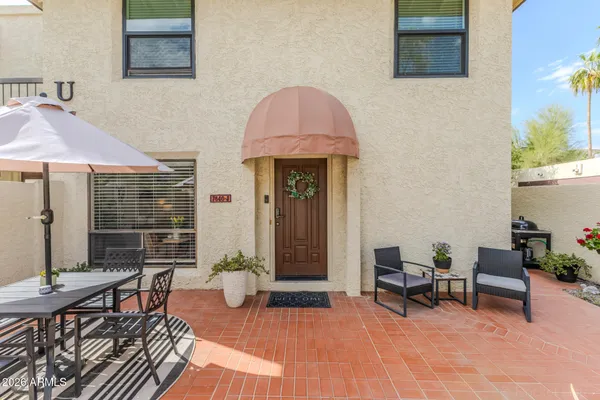 a front view of a house with outdoor seating