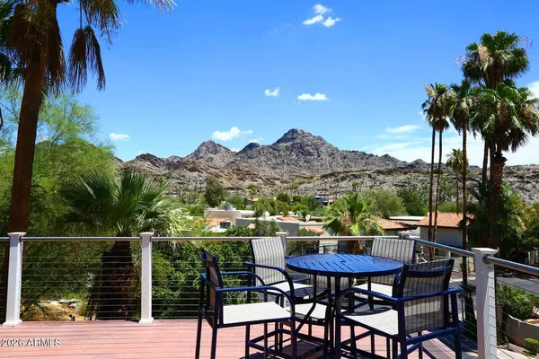 a view of a chairs and table in patio