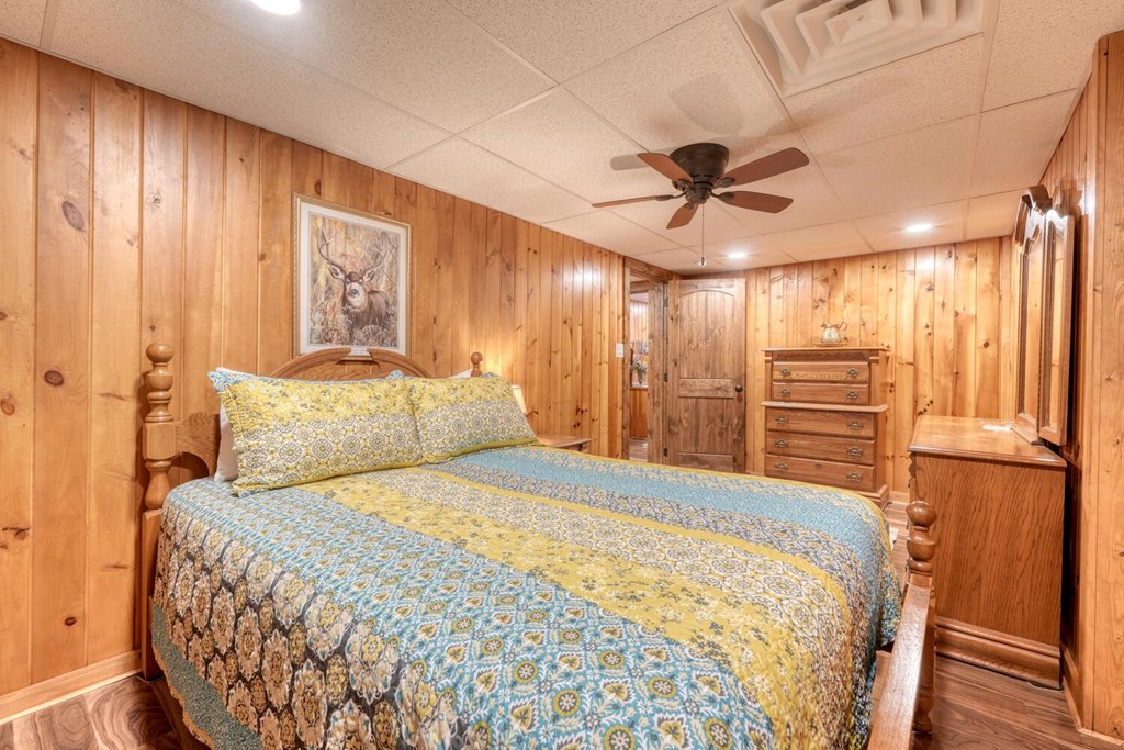 450 Mull Valley Road Morganton, GA 30560 - Photo 19 of 36 a bedroom with a bed and a chandelier
