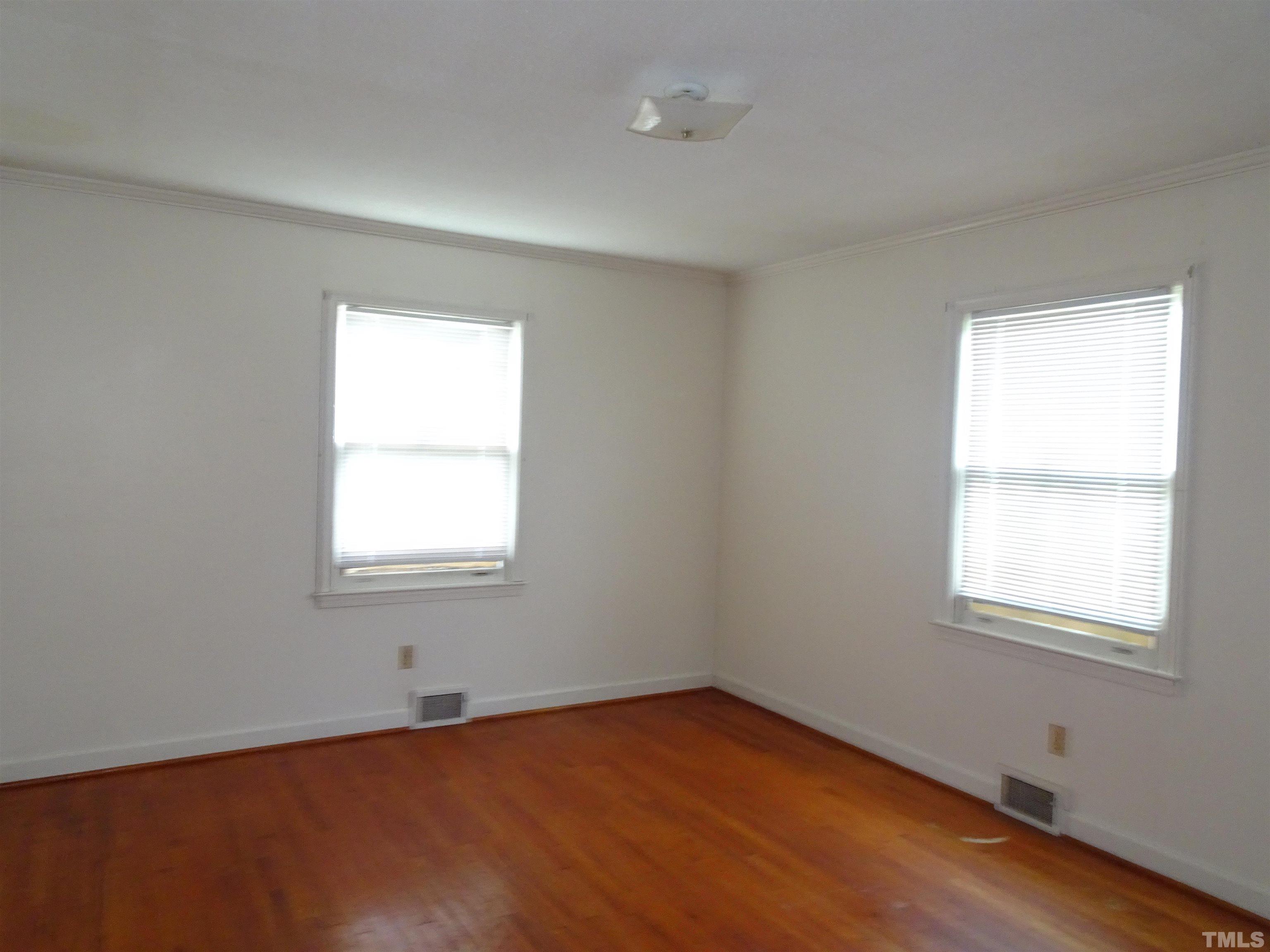 1619 Warrenton Road Henderson, NC 27537 - Photo 17 of 51 2nd bedroom on the right also has hardwood floor.