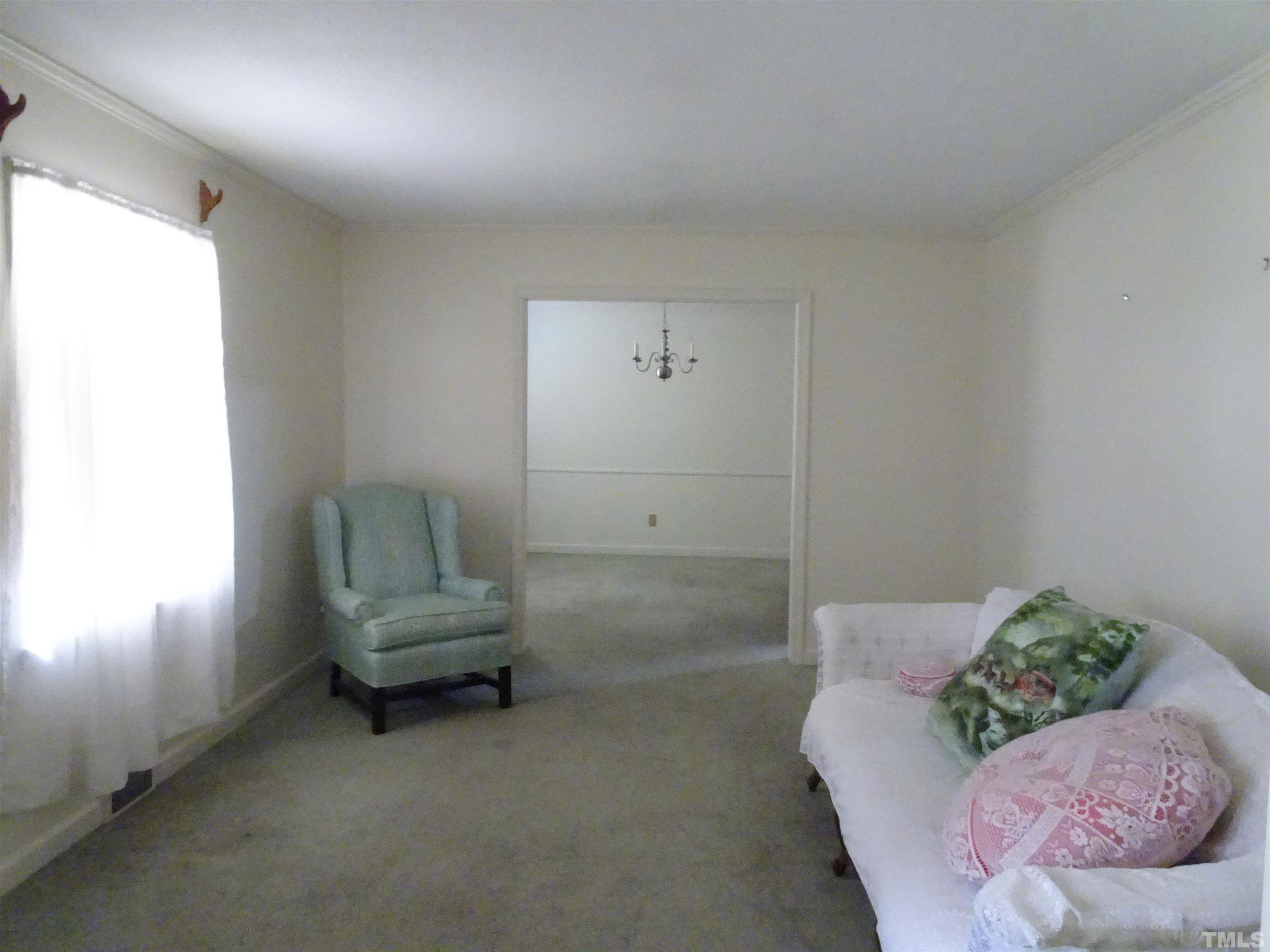 1619 Warrenton Road Henderson, NC 27537 - Photo 4 of 51 The living room has a large picture window, carpet and access from the foyer and dining room.