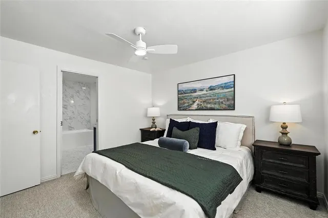 a bedroom with a bed and a lamp