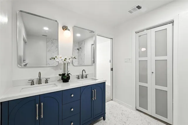 a bathroom with a double vanity sink mirror and double