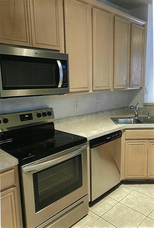 8609 Hunters Trace Lane Plano, TX 75024 - Photo 3 of 5 a kitchen with granite countertop white cabinets and black appliances