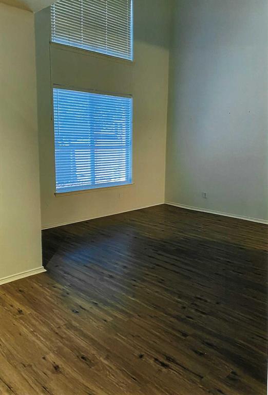 8609 Hunters Trace Lane Plano, TX 75024 - Photo 4 of 5 a view of an empty room with wooden floor and a window