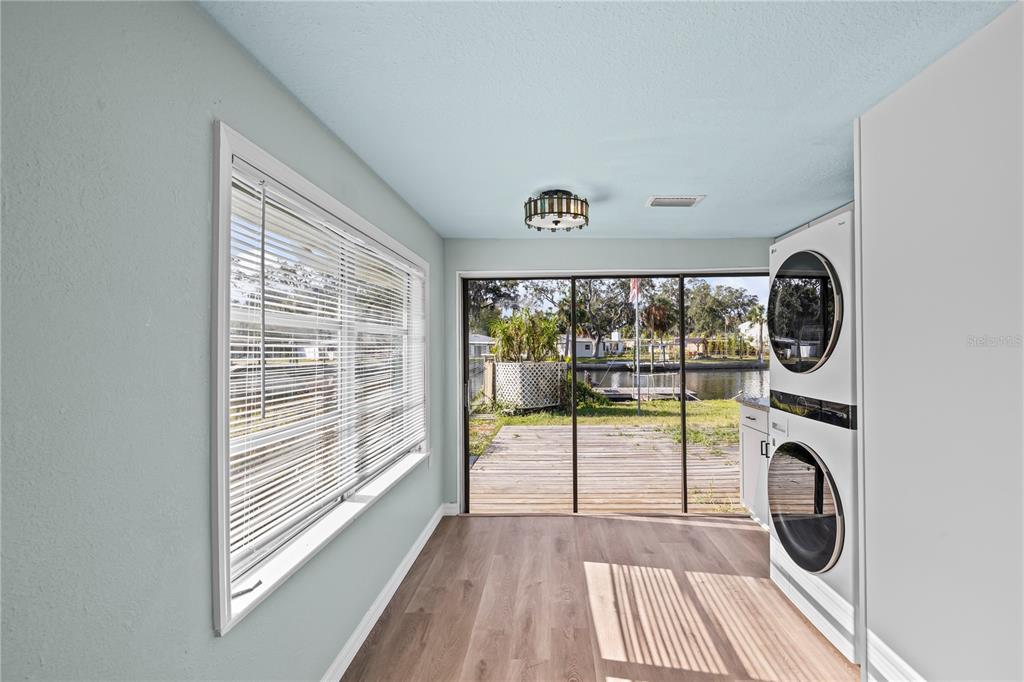 5642 Riverview Drive New Port Richey, FL 34652 - Photo 11 of 41 a view of a room with wooden floor and large window