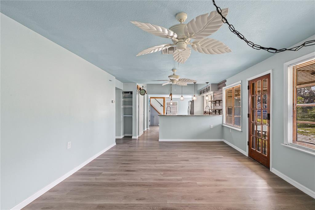 5642 Riverview Drive New Port Richey, FL 34652 - Photo 15 of 41 a view of a room with wooden floor and staircase