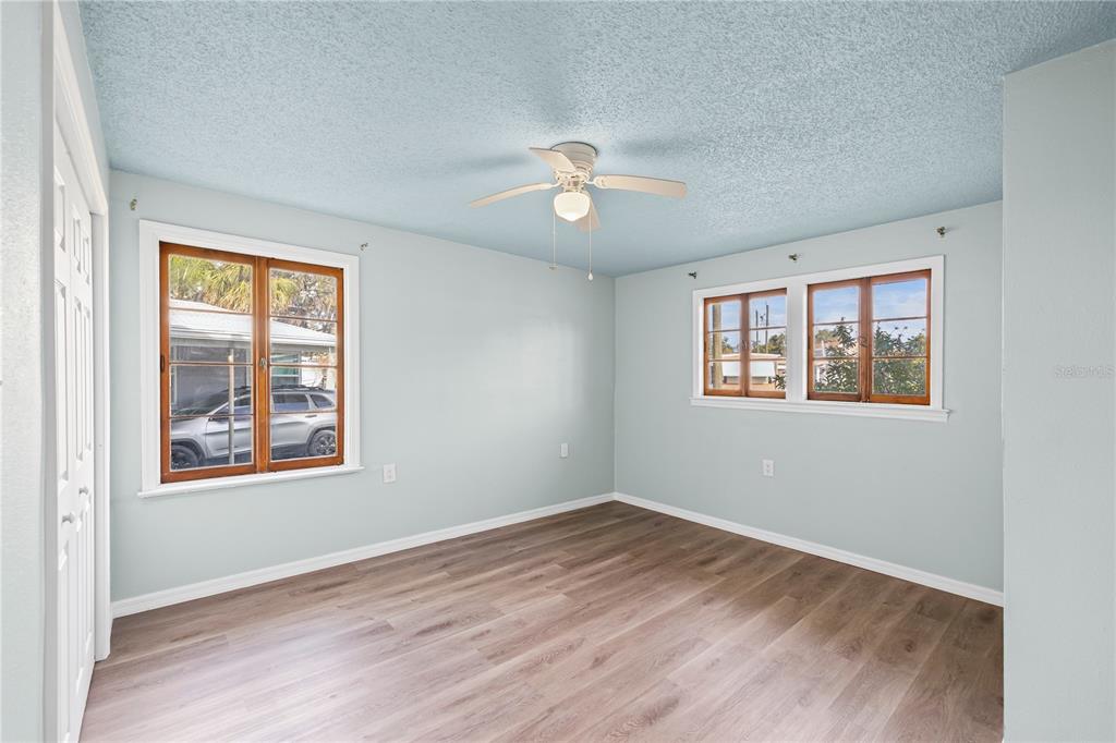 5642 Riverview Drive New Port Richey, FL 34652 - Photo 17 of 41 wooden floor in an empty room with a window