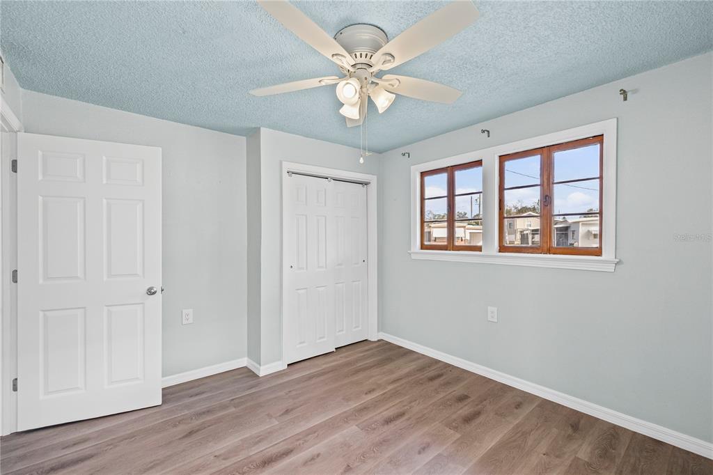 5642 Riverview Drive New Port Richey, FL 34652 - Photo 20 of 41 wooden floor in an empty room with a window
