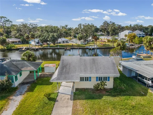 an aerial view of a house with a lake view