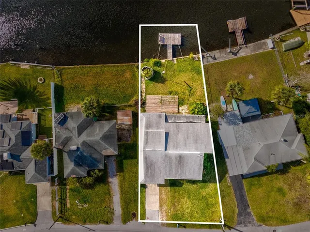 aerial view of a house with swimming pool and porch