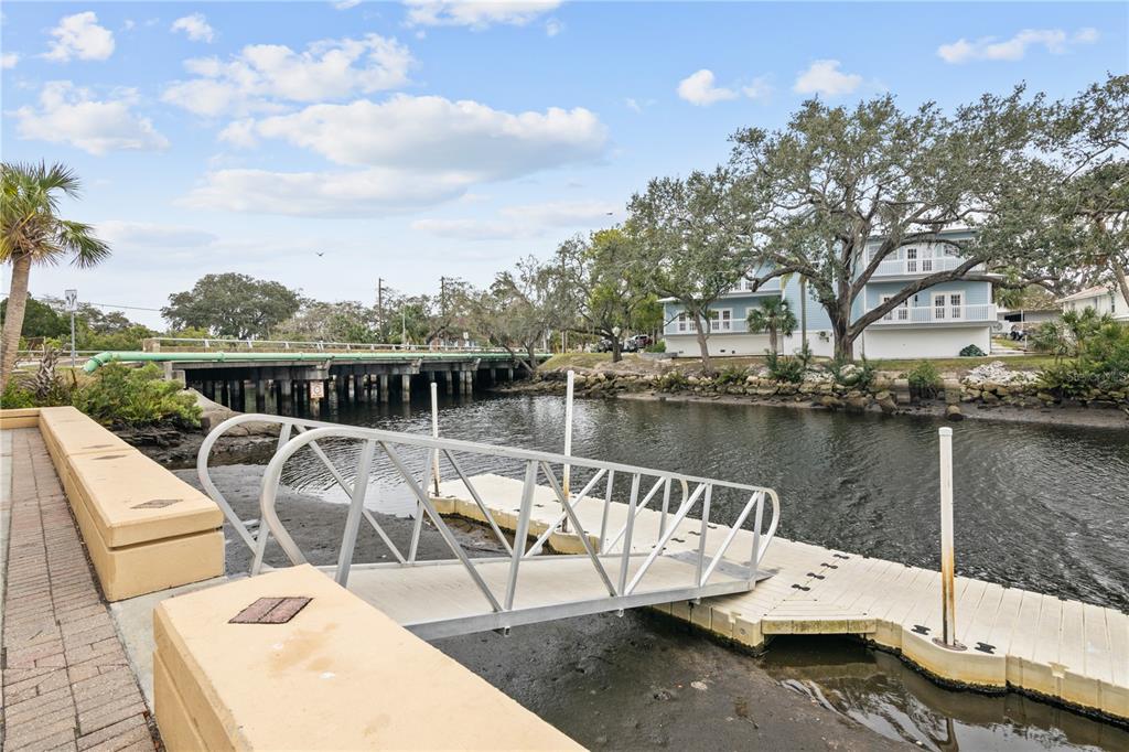 5642 Riverview Drive New Port Richey, FL 34652 - Photo 36 of 41 a view of a lake with couches chairs and wooden floor