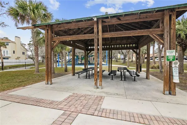 a view of a patio with a table and chairs under an umbrella