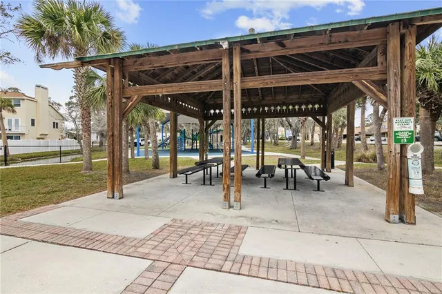 a view of a patio with a table and chairs under an umbrella