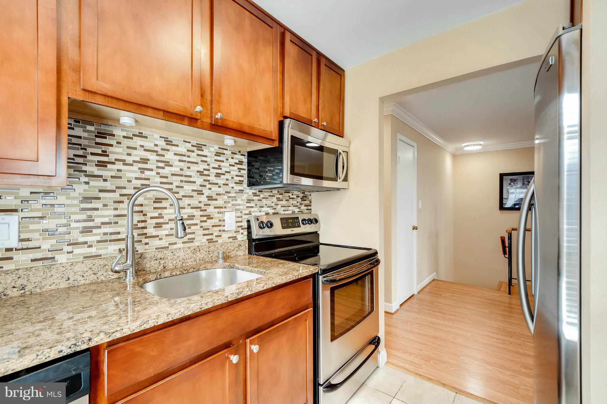 620 Charles Street, Unit R33 Baltimore, MD 21230 - Photo 5 of 27 a kitchen with stainless steel appliances granite countertop a sink stove and refrigerator