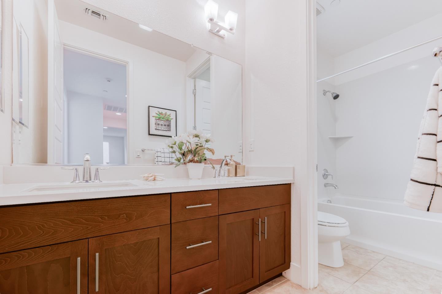 37431 Talamore Common Fremont, CA 94536 - Photo 24 of 41 a bathroom with a sink a toilet a large mirror and shower