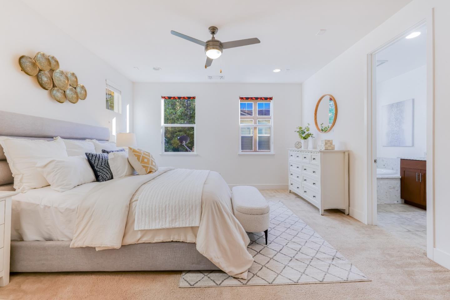 37431 Talamore Common Fremont, CA 94536 - Photo 25 of 41 a spacious bedroom with a bed a window and a chandelier