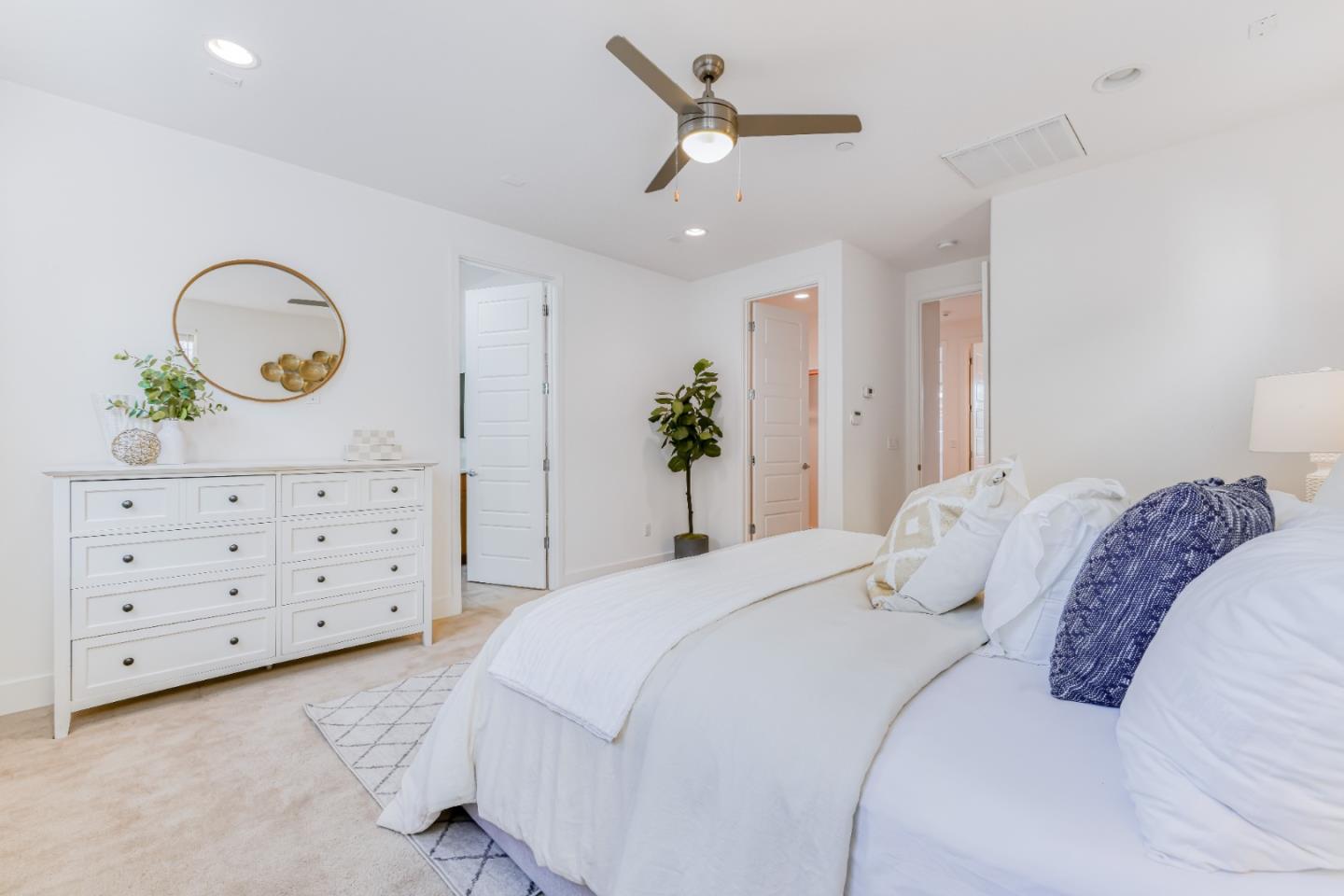 37431 Talamore Common Fremont, CA 94536 - Photo 26 of 41 a bedroom with a bed a chandelier and a dresser