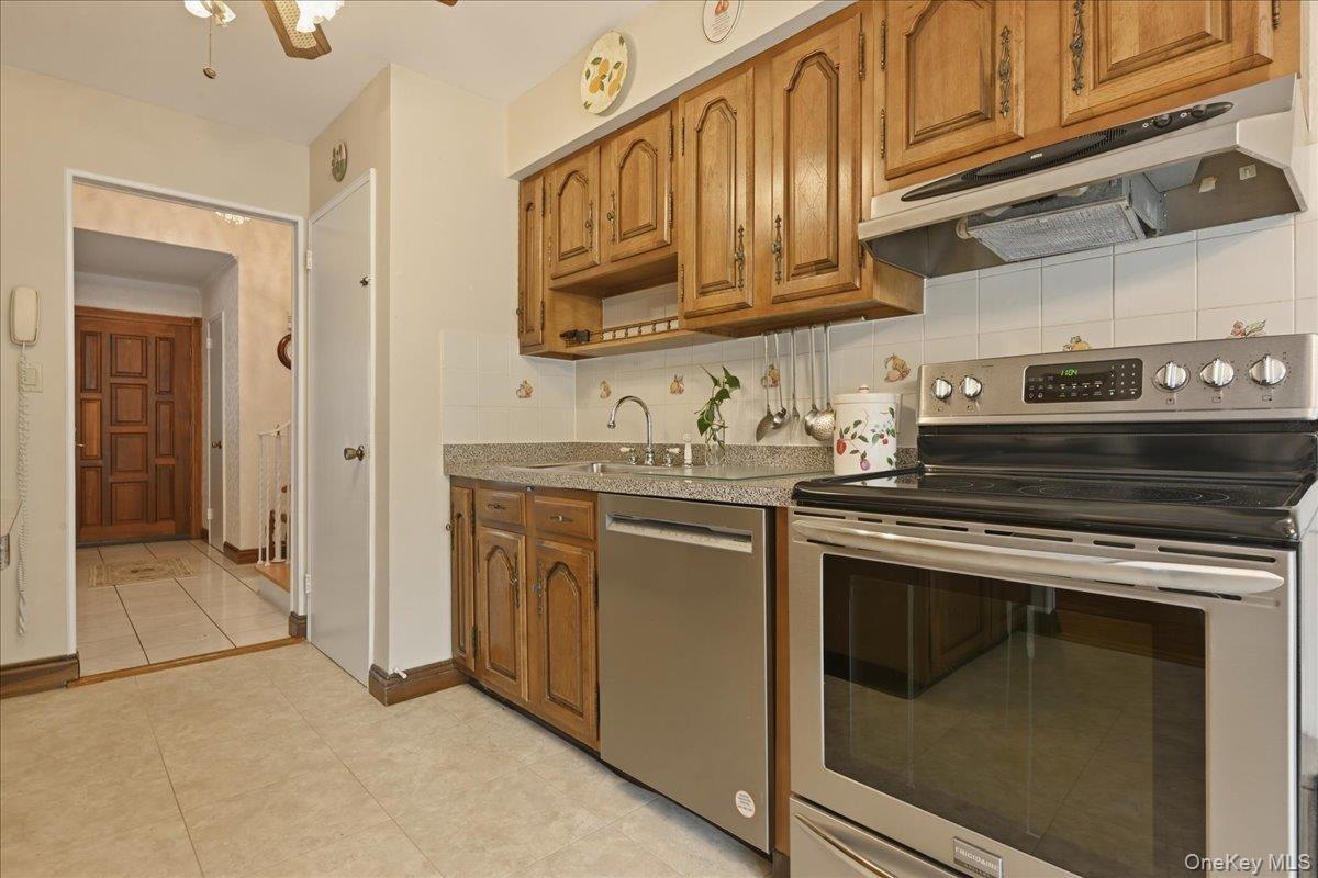 17 Avon Road Farmingdale, NY 11735 - Photo 13 of 46 a kitchen with stainless steel appliances granite countertop a stove and a microwave