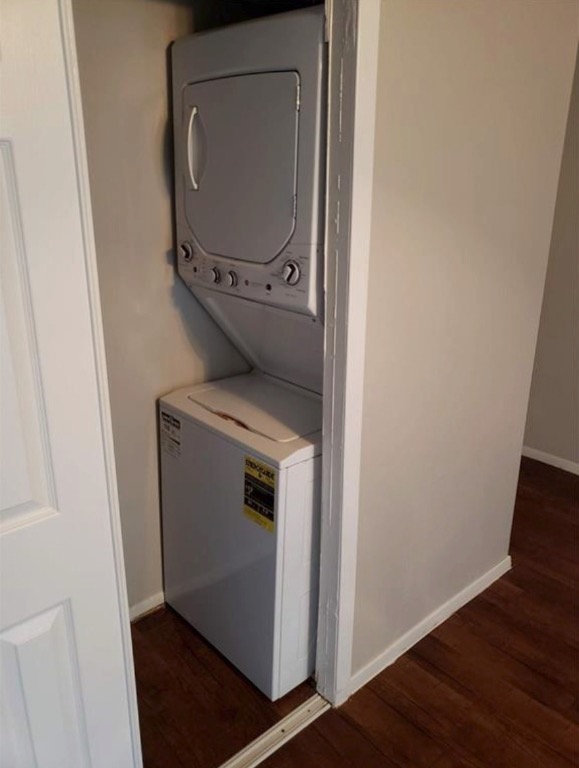 1202 Newning Avenue, Unit 113 Austin, TX 78704 - Photo 11 of 13 Laundry room featuring stacked washer and clothes dryer and wood finished floors
