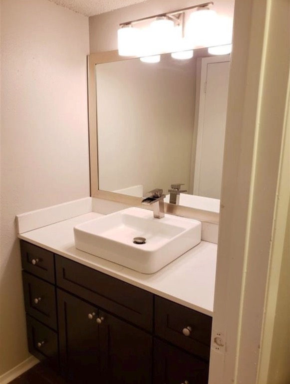 1202 Newning Avenue, Unit 113 Austin, TX 78704 - Photo 7 of 13 Bathroom featuring vanity and a textured ceiling