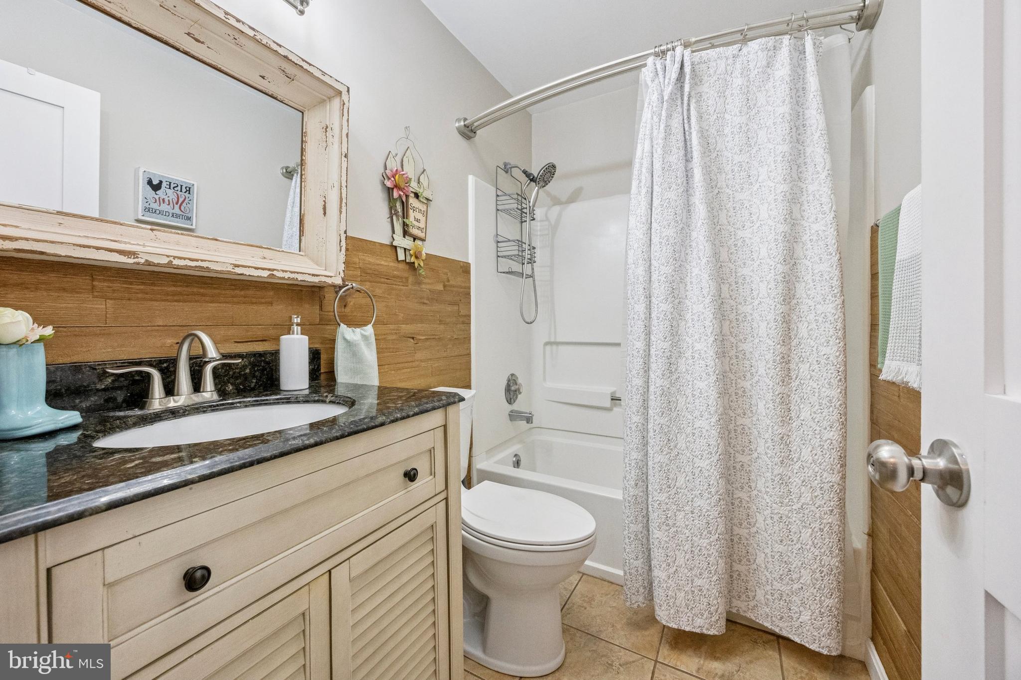 984 Rill Road Reading, PA 19606 - Photo 15 of 26 a bathroom with a granite countertop sink toilet a shower and a mirror