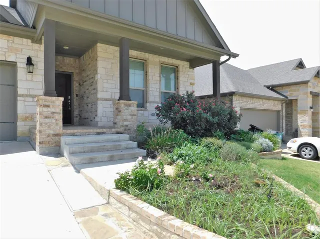 a front view of a house with garden