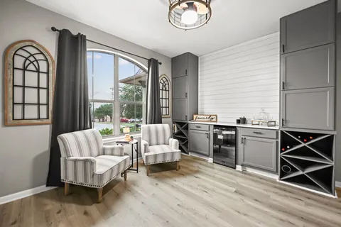 a living room with furniture and large windows