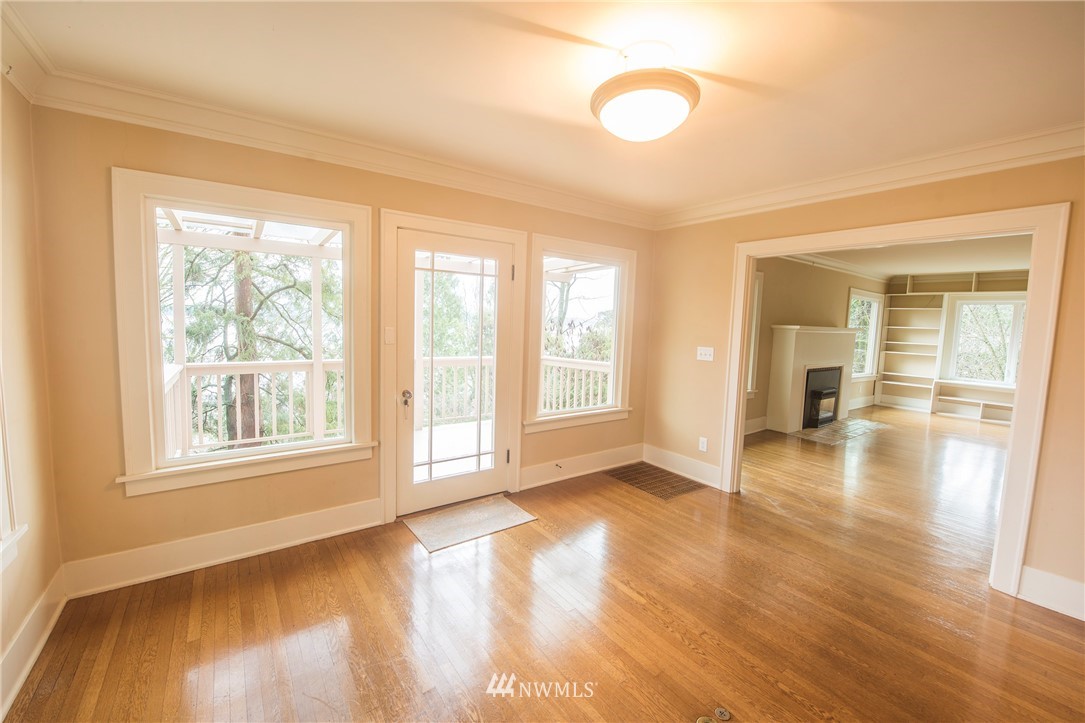412 36th Avenue Seattle, WA 98122 - Photo 12 of 25 a view of an empty room with wooden floor and a window