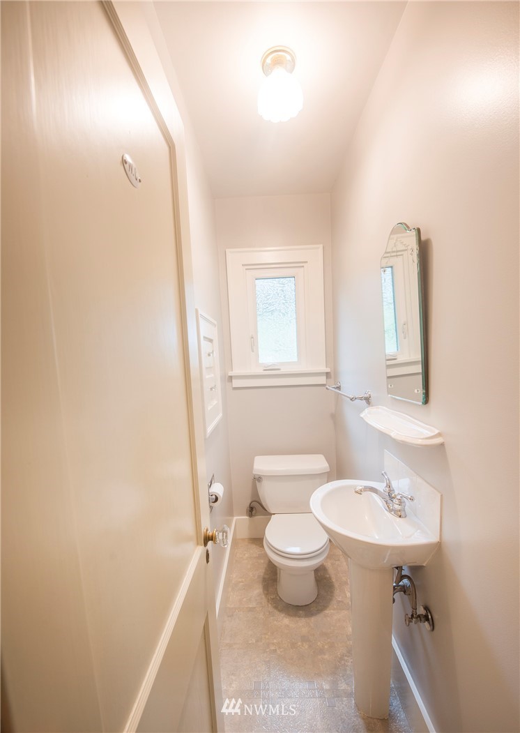 412 36th Avenue Seattle, WA 98122 - Photo 15 of 25 a bathroom with a sink toilet a mirror and shower