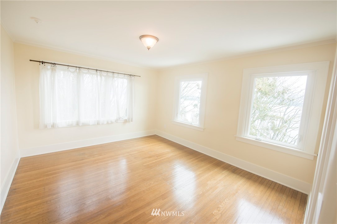 412 36th Avenue Seattle, WA 98122 - Photo 19 of 25 a view of an empty room with wooden floor and a window
