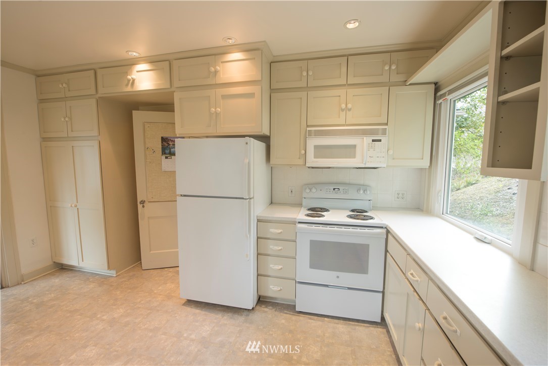 412 36th Avenue Seattle, WA 98122 - Photo 6 of 25 a kitchen with a refrigerator sink stove and cabinets