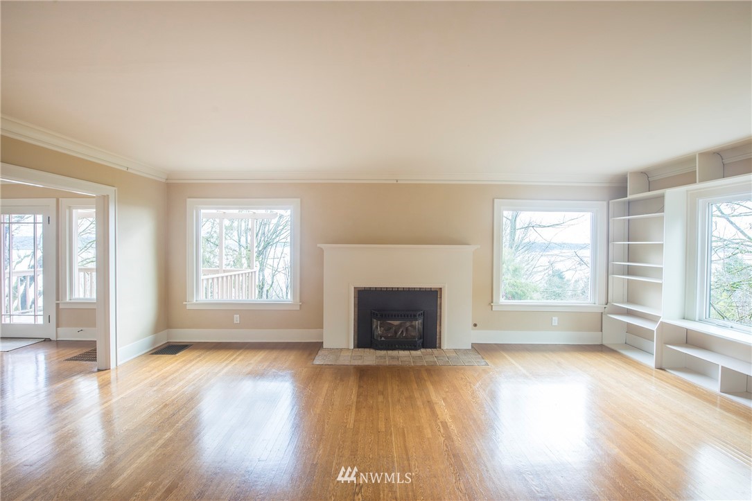 412 36th Avenue Seattle, WA 98122 - Photo 8 of 25 an empty room with wooden floor and windows