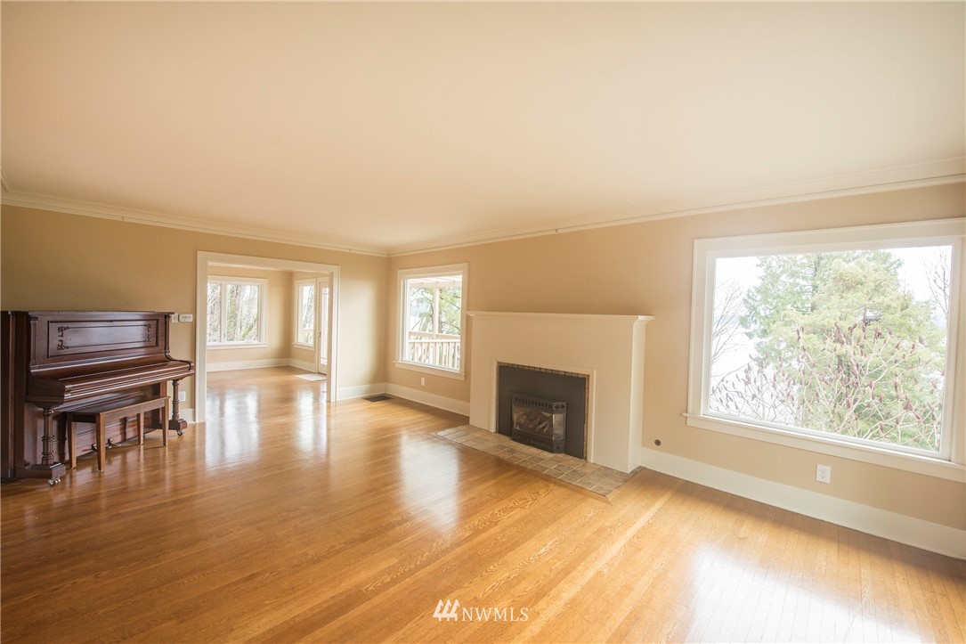 412 36th Avenue Seattle, WA 98122 - Photo 9 of 25 a view of empty room with fireplace and wooden floor