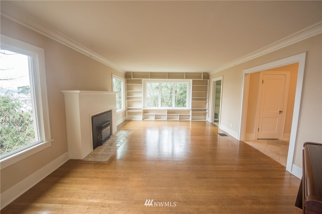 412 36th Avenue Seattle, WA 98122 - Photo 10 of 25 a view of empty room with wooden floor and fireplace