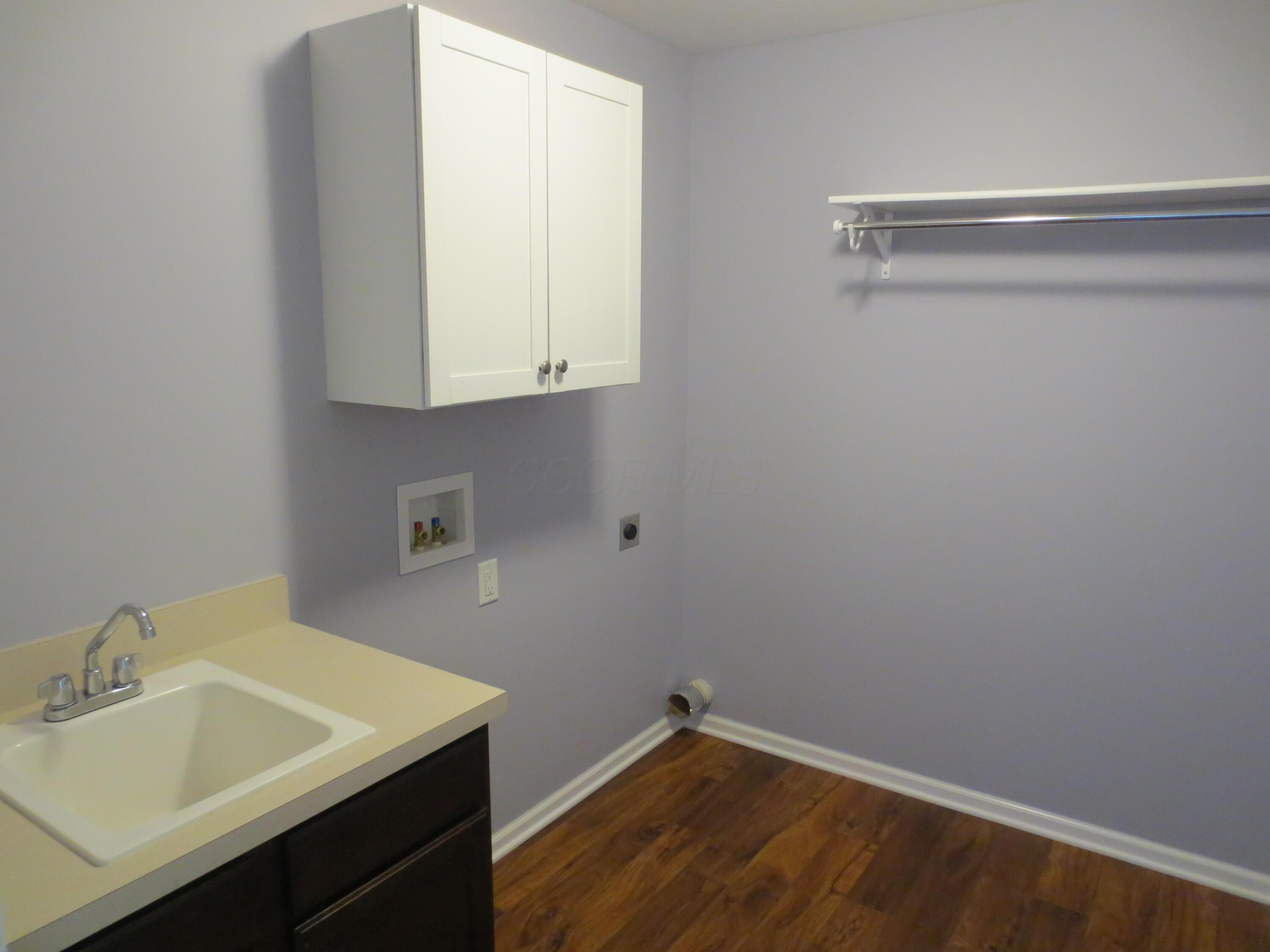 101 Merriston Circle Delaware, OH 43015 - Photo 23 of 34 First floor laudry room with sink and cabinets